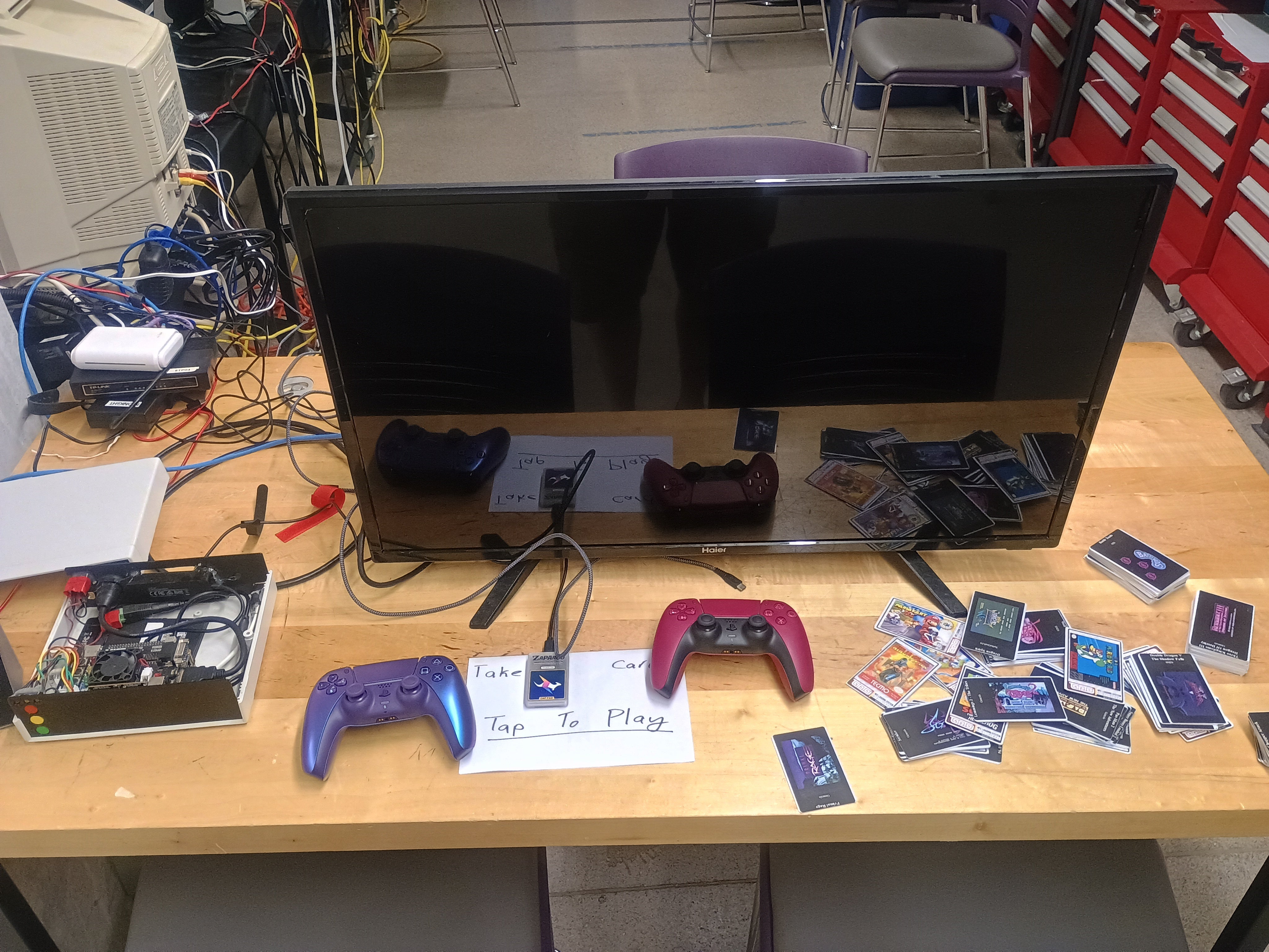 Station with retro video games and gaming controllers.