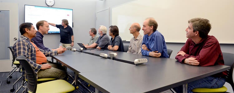 Meeting of 9 CSCF folk around a board-room table