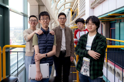 Assistant Professor, Yizhou Zhang, standing next to three graduate students and an undergraduate student