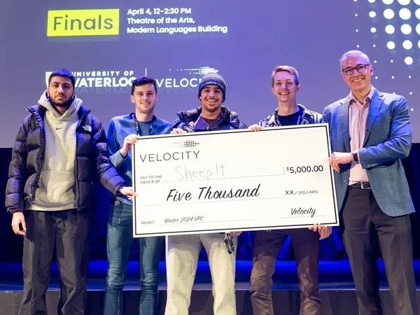 Photo of team holding a $5,000 cheque