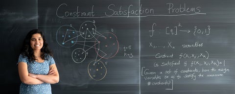 Professor Santhoshini Velusamy in front of blackboard