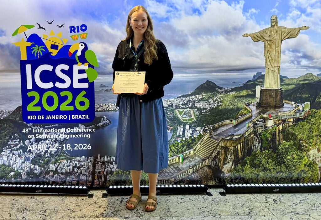 Evelien Riddell holding a best papaer award certificate at FORGE 2026 / ICSE 2026 conference