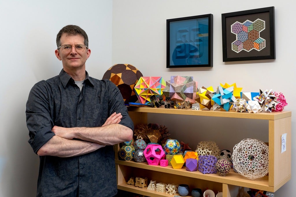 Professor Craig S. Kaplan in his office with many the geometric shapes and objects 