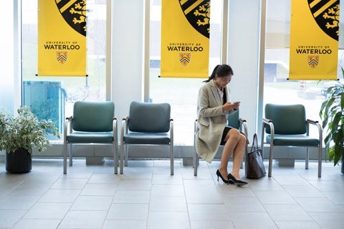 student preparing for an interview while sitting in a waiting room