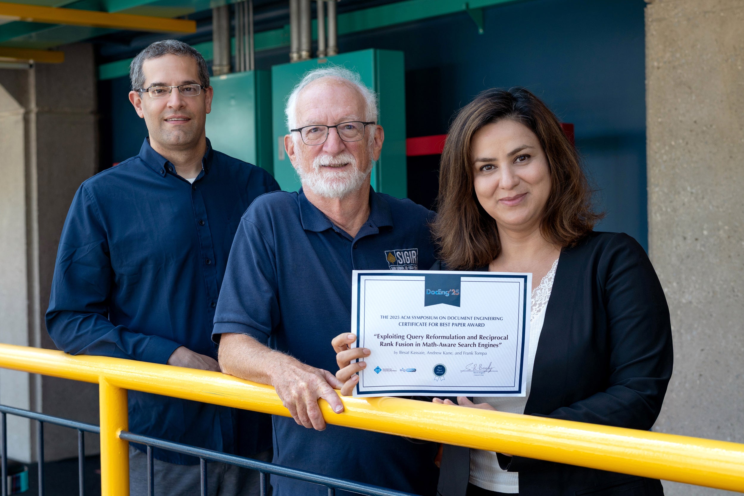 Andrew Kane, Frank Tompa, Besat Kassaie in Davis Centre holding best paper award certificate