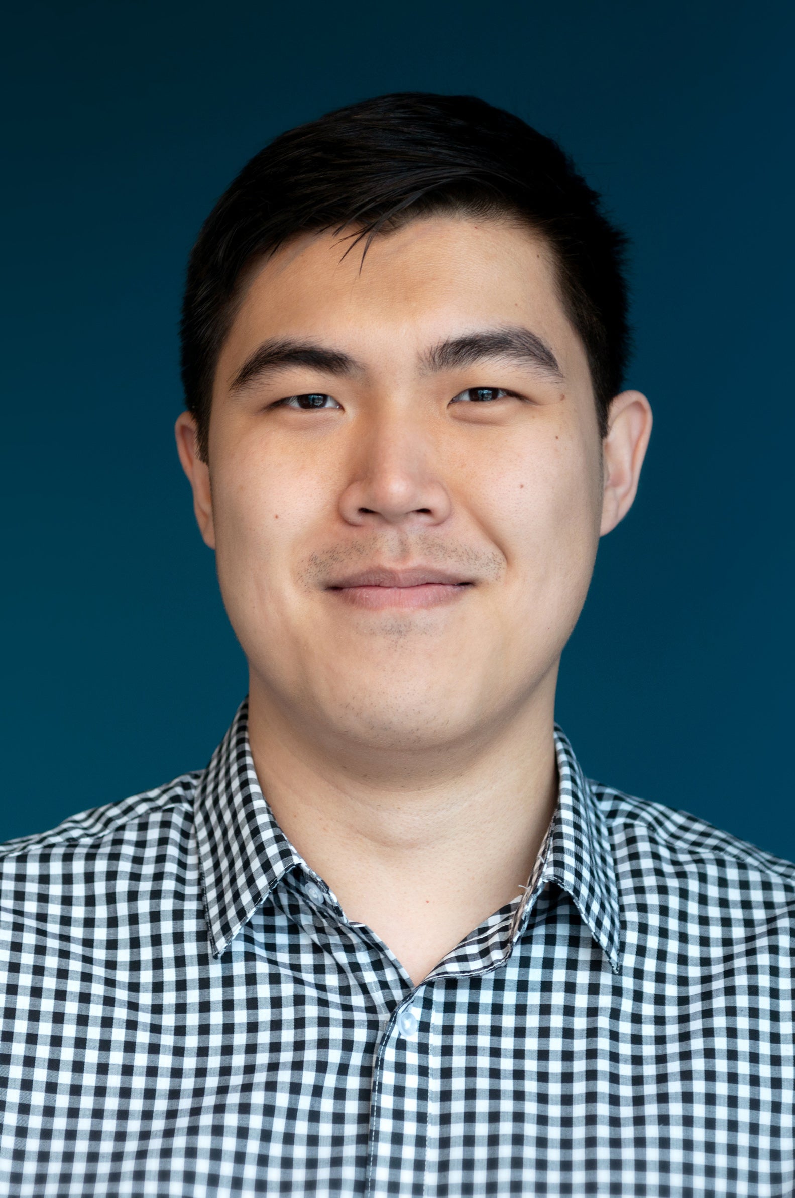 Photo of Bing Hu with blue background