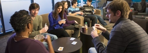 Graduate students playing cards in the lounge