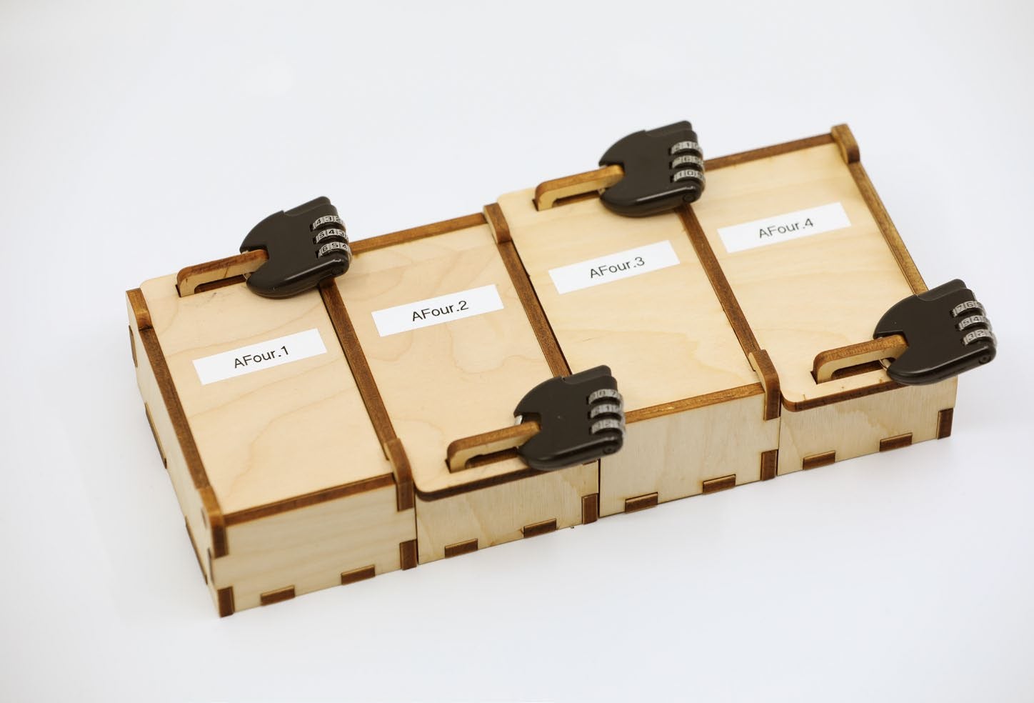 Four wood boxes with a black key on top of it. Each box's label says "AFour.Box#"