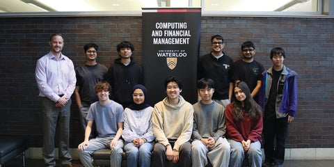 Ten students and one professor posing in front of a banner that reads Computing and Financial Management