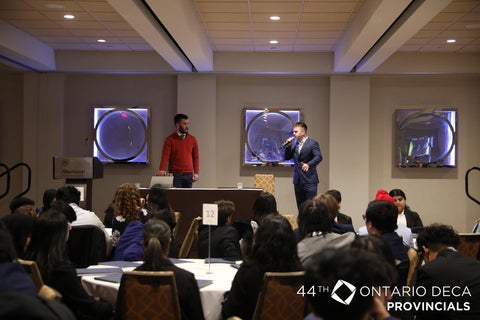CFM student Piero speaking to an audience at the DECA Provincials in the Toronto Sheraton Centre