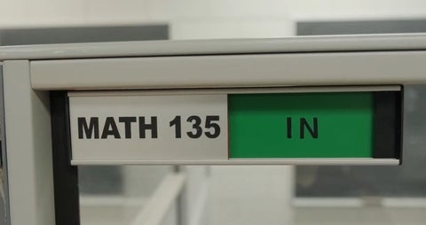 A door tag showing that the Math 135 tutor is in