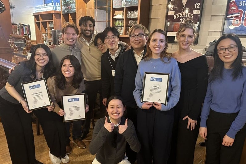 Students holding award plaques and celebrating