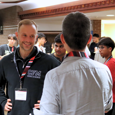 Professor James Thompson socializing with an alumnus