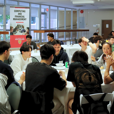 Students sitting and eating at a formal table