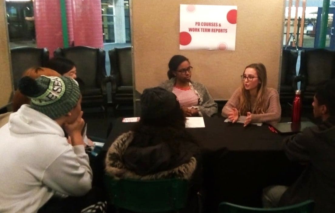 Two female students leading a talk in front of students