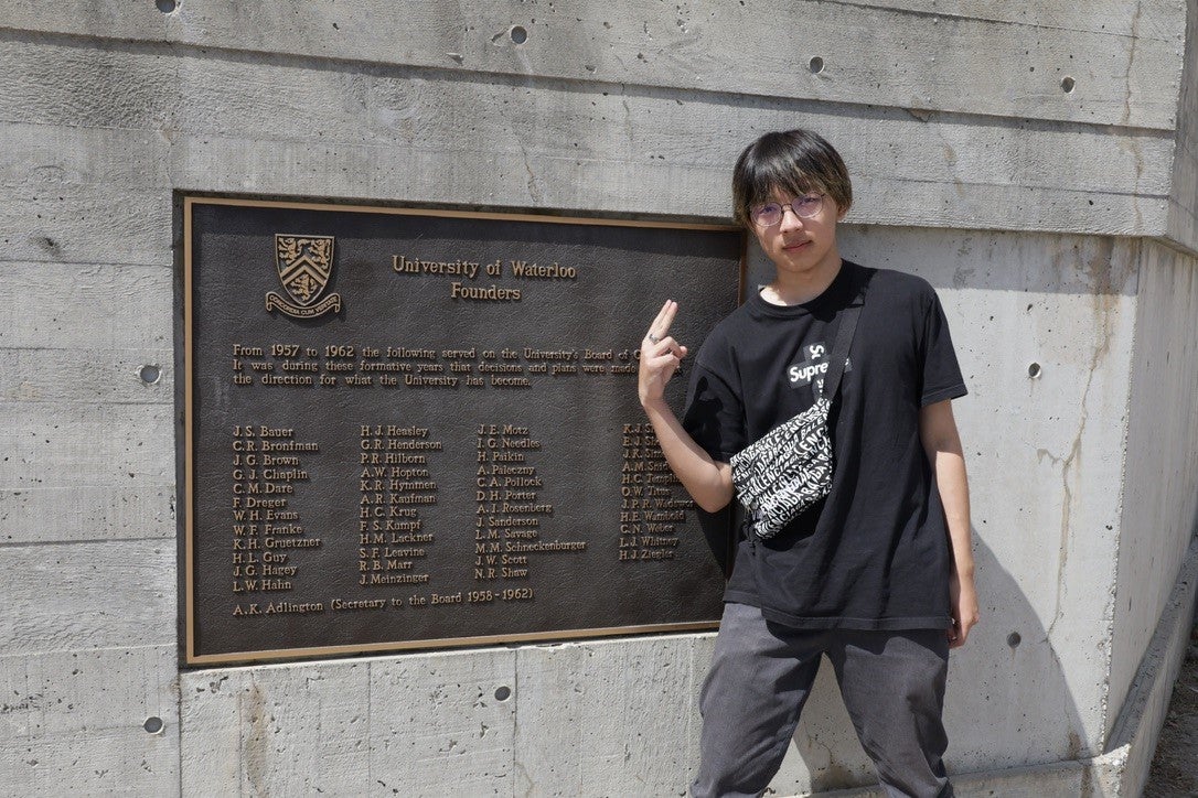 Photo of Alex with the UWaterloo sign
