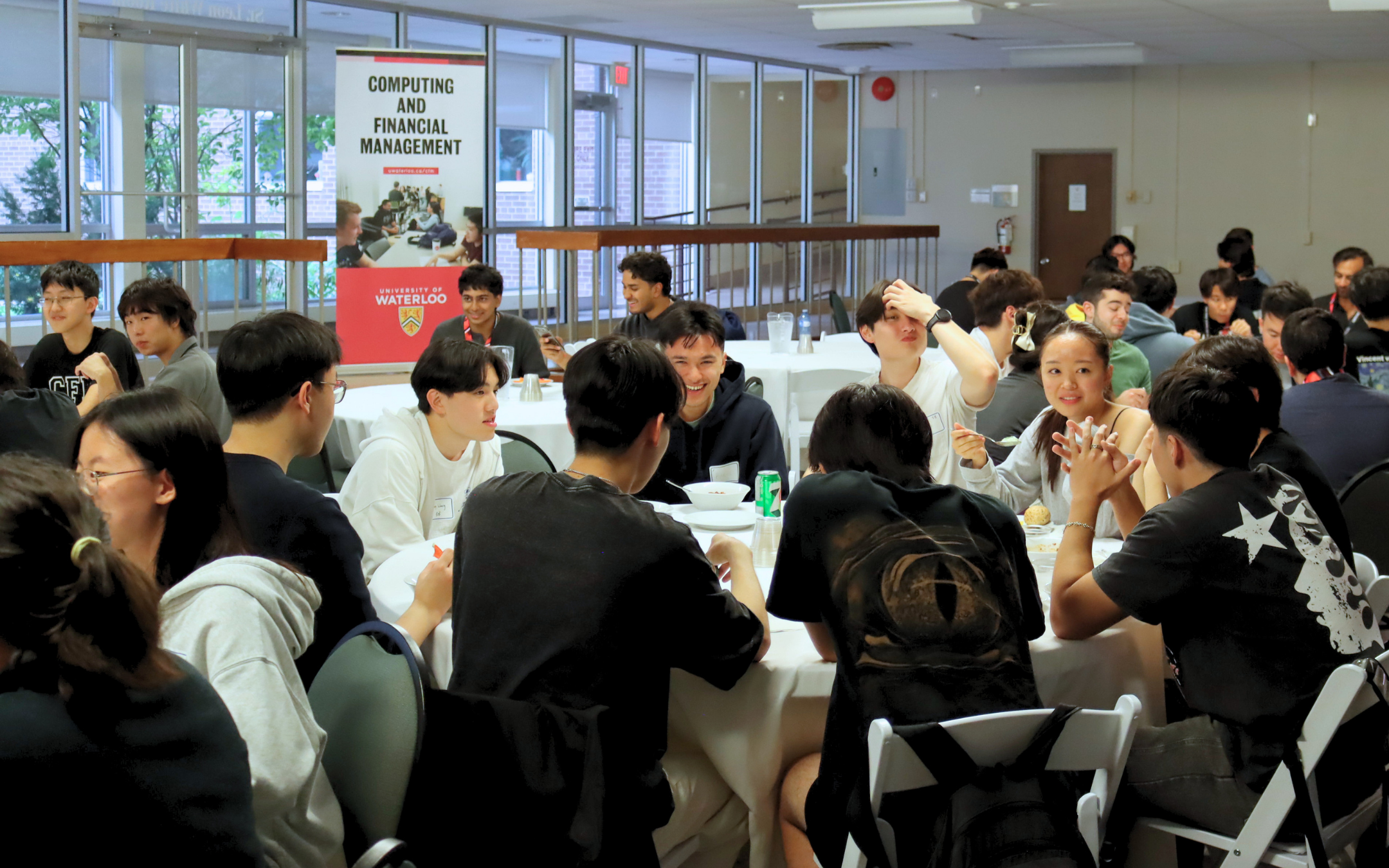Students sitting and eating at a formal table