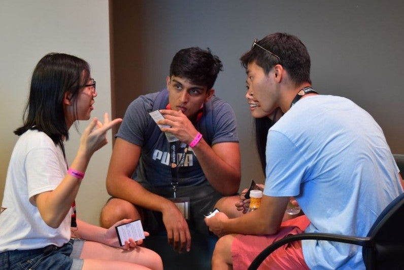 Four students talking together