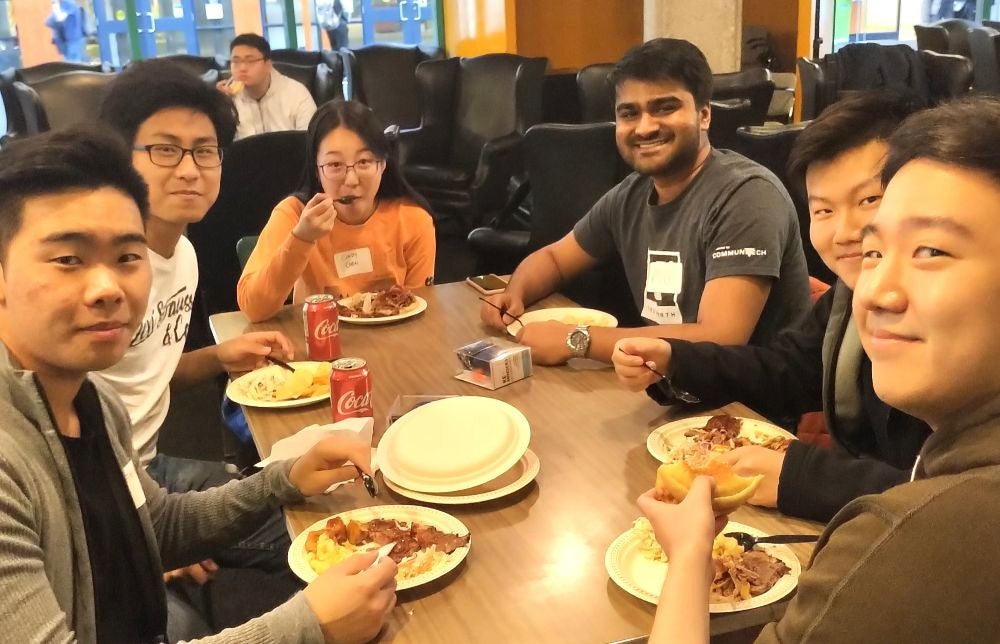Six students eating breakfast together