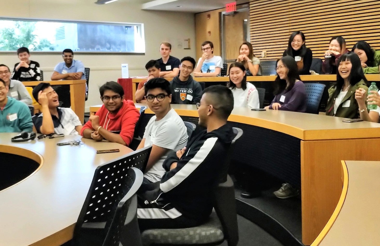 Students laughing in a lecture hall