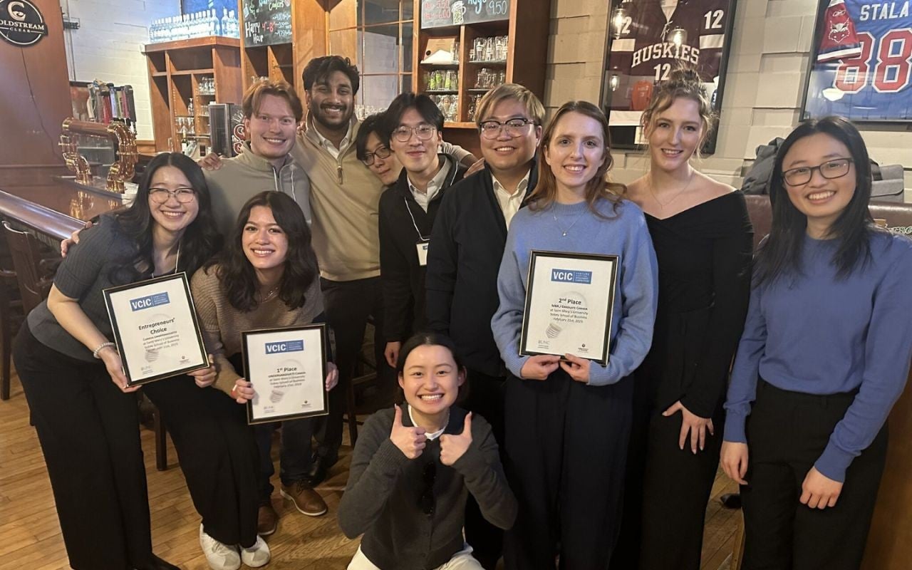 Students holding award plaques and celebrating