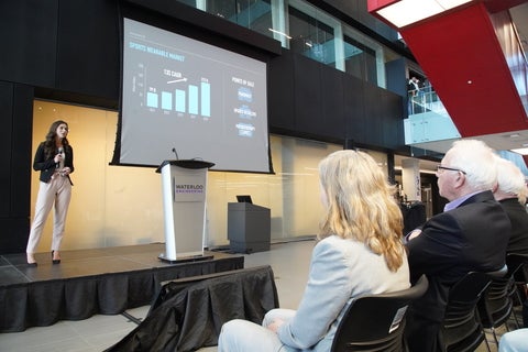 Norman Esch Pitch Competition student on stage with audience listening