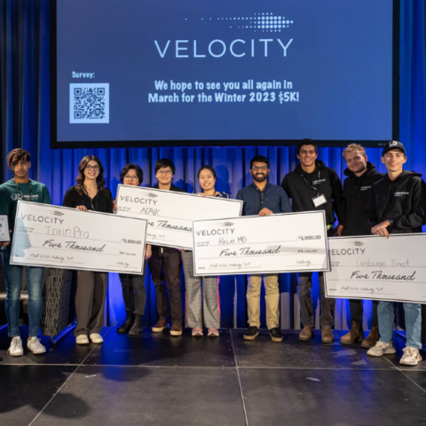 Conrad School students on stage after winning one of four awards at the Fall 2022 Velocity 5K pitch competition