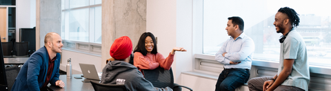 A group of MBET students gather in conversation