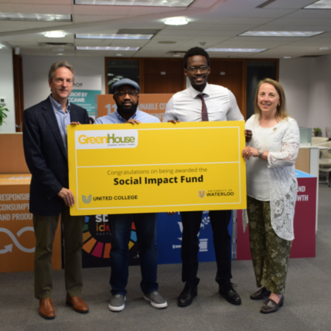 Ernest Mwesigye (MBET '23) and Chinazom Uwaoma (MBET '25) posing with their cheque from winning the Social Impact Showcase - Spring 2023