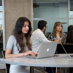 Student sitting and working on mac laptop