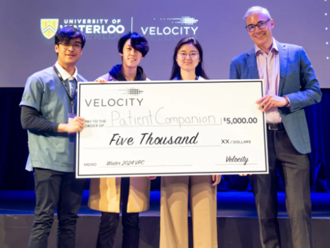 winning team poses with cheque