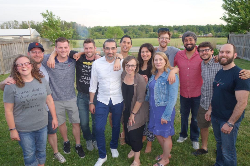 A large group of part-time MBET students at a backyard BBQ gathering.