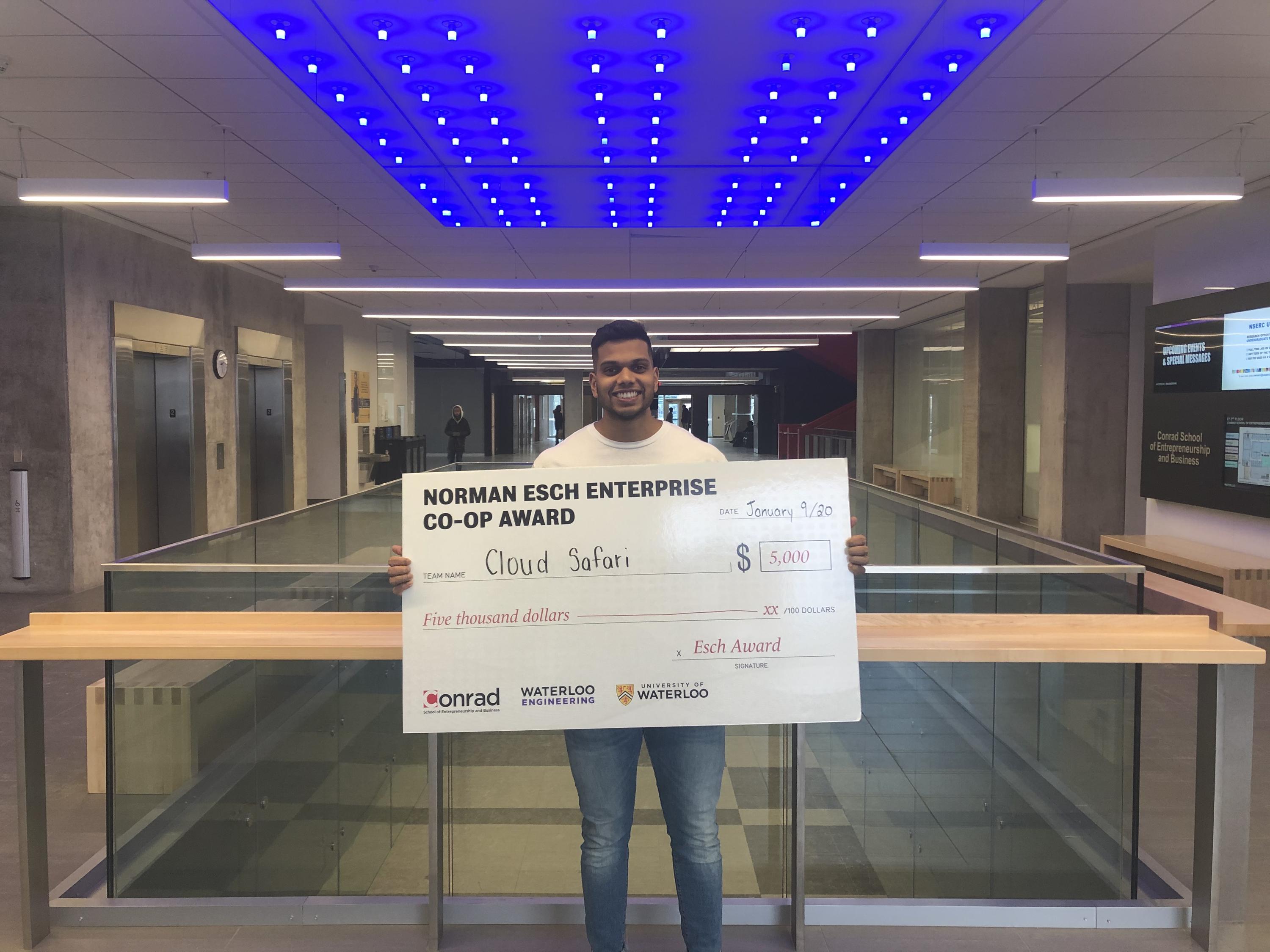 Joshua D'Souza, founder of Cloud Safari holding cheque for $5,000