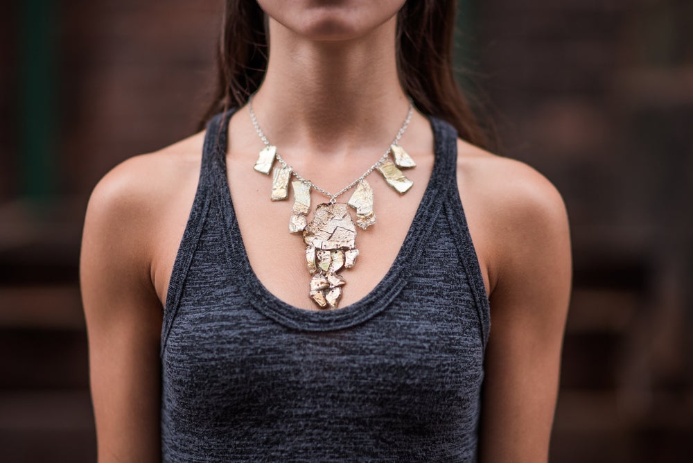 Model wearing necklace made from CDs