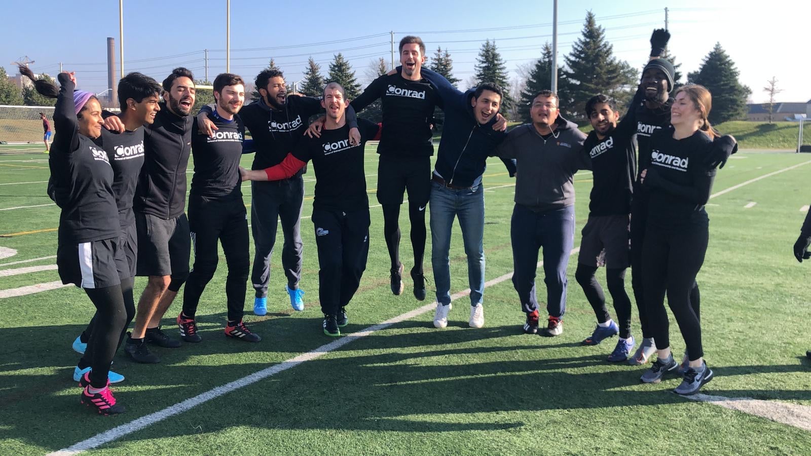 Sporty MBETs: A group of full-time MBET students celebrate a win on Warrior Field.