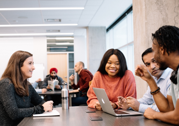 Diverse group of students sitting around table