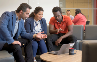 Collaborators gathered around a table in discussion.