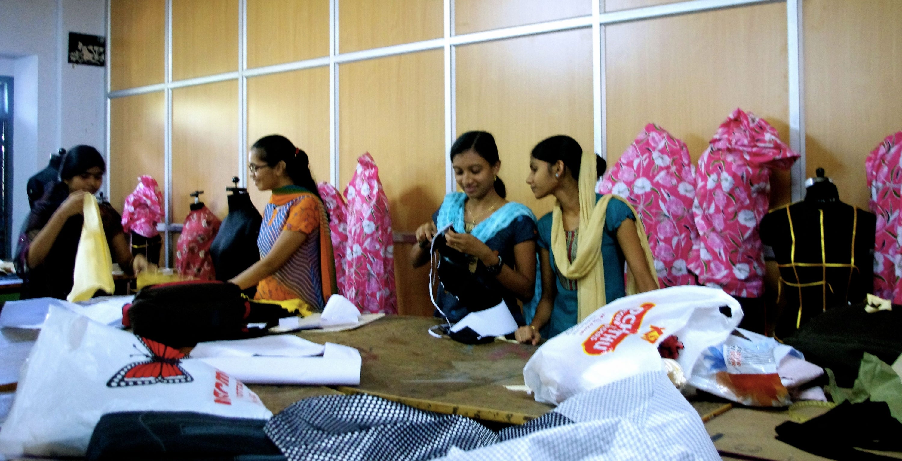 Indian women working with fabrics