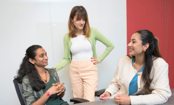 Three students sit together talking_Conrad_undergrad