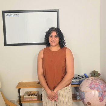 Divya Lala, MBET '25, standing in front of a whiteboard