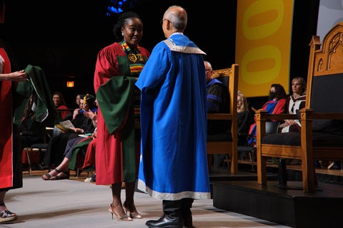 Graduation student with President and Vice Chancellor