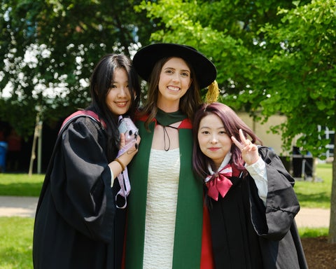 Undergrads and PhD grad in regalia