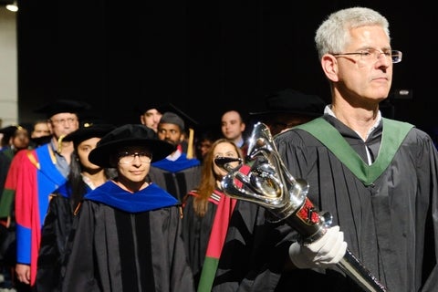 Mace barer and faculty processing into convocation