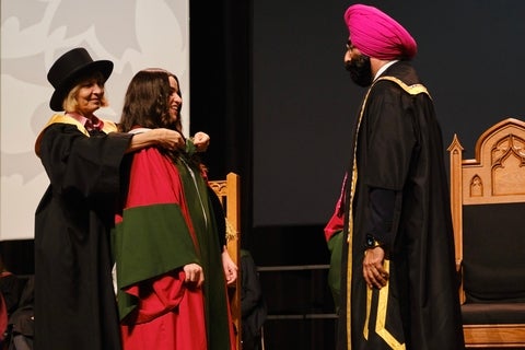 PhD graduate receiving their hood
