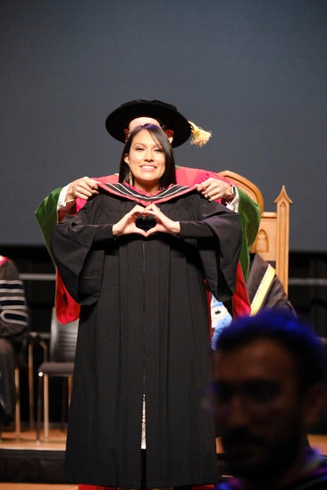Grad being hooded on stage