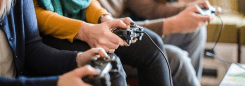 People holding hand held gaming devices