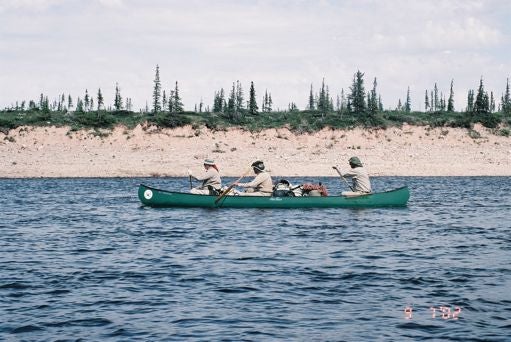 Qallunaat tavelling by canoe. 