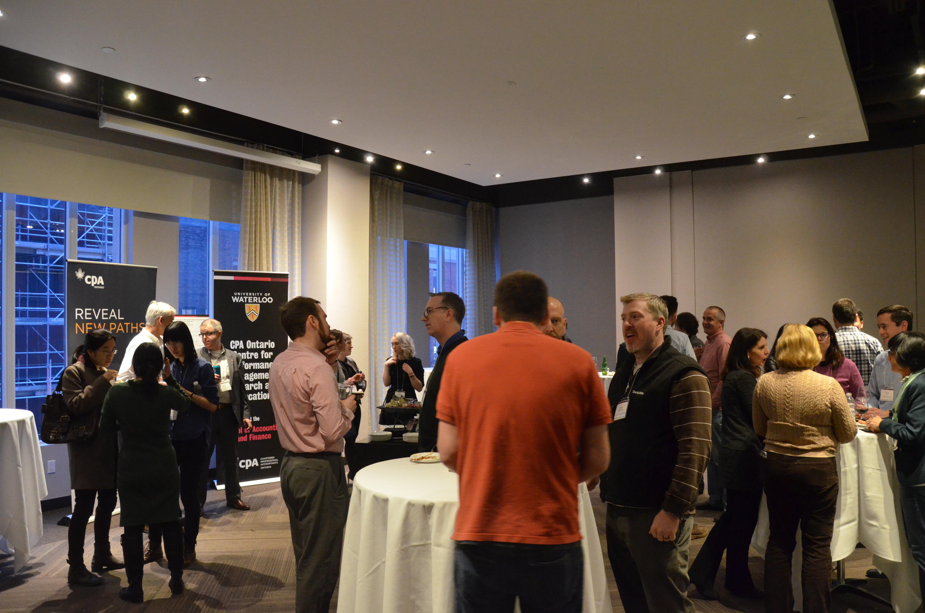 Attendees networking during evening reception