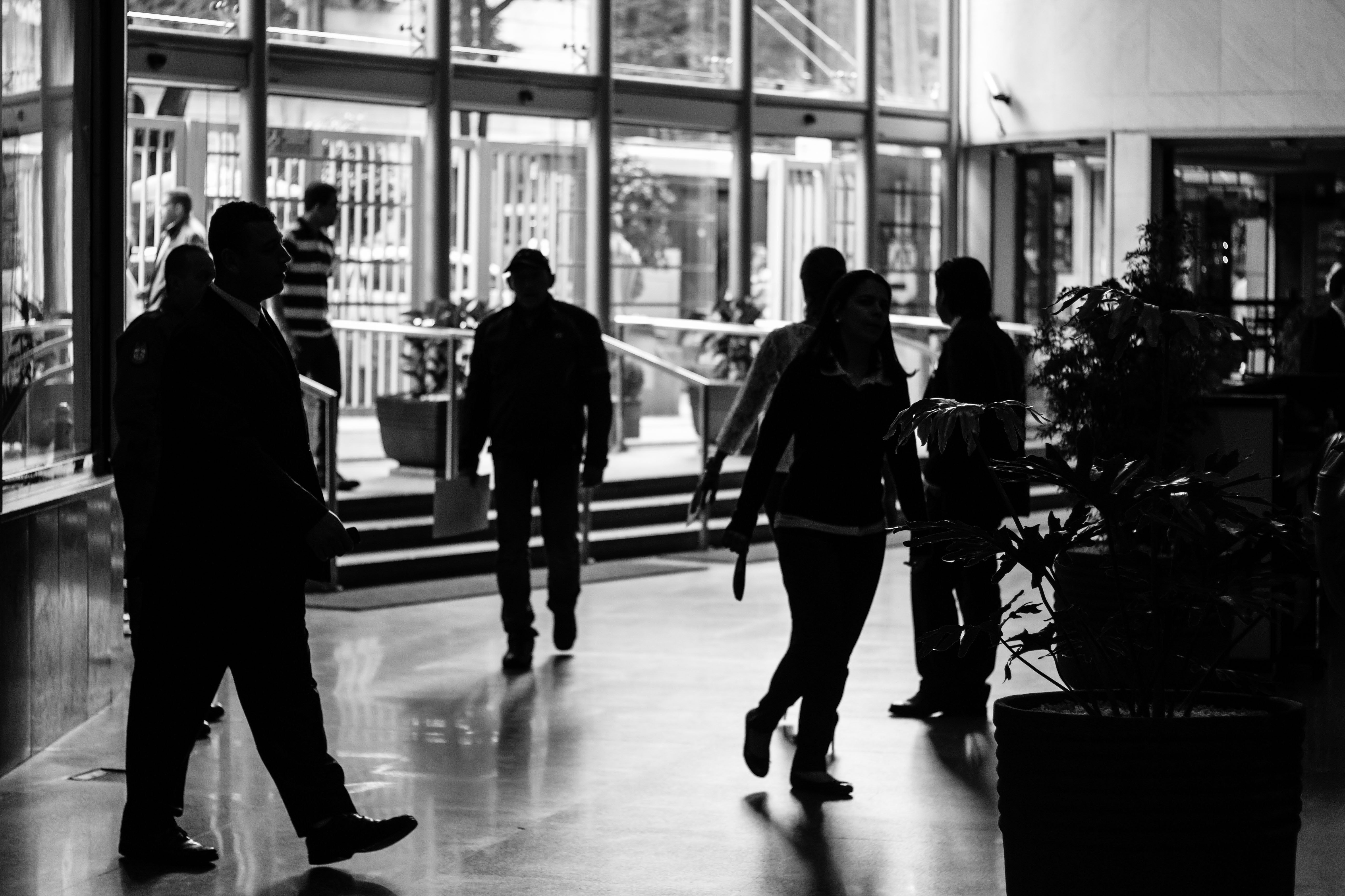 People walking in office, black and white colour filter