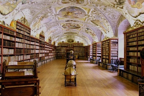old library showing book shelves and globes